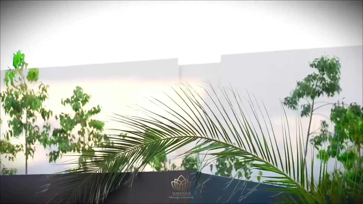 Thérapeute SB Massage en tenue officielle préparant une table avec des pétales de roses